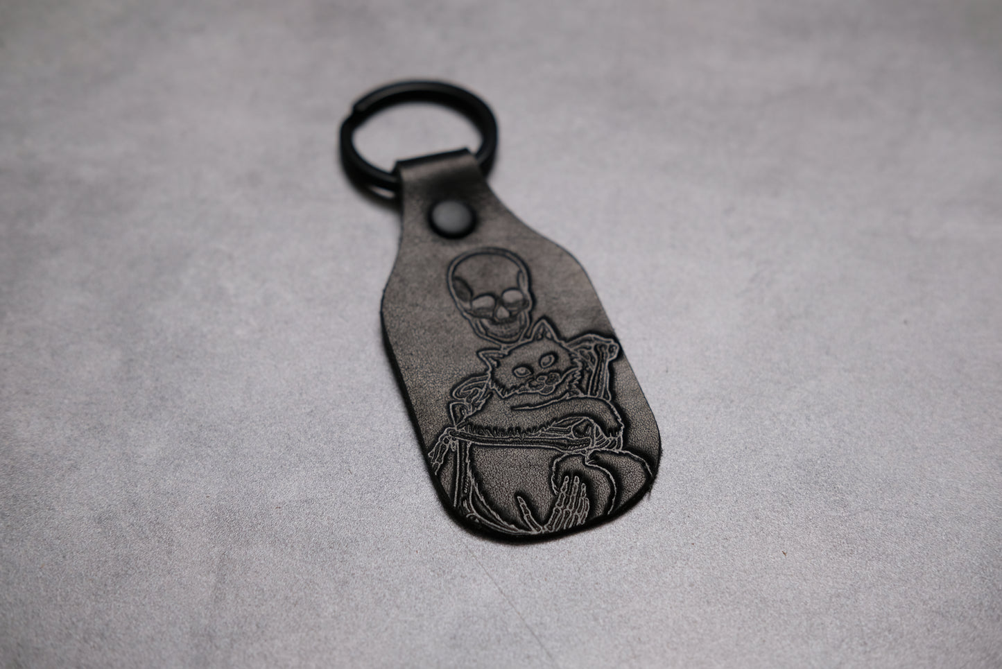 Skeleton holding a cat - Leather Keychain